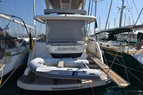 Absolute 50 Fly: stern-to in the marina with grey inflatable tender sitting on the bathing platform