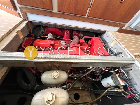 Aquastar Oceanranger 33: engine bay with red diesel engine and white tanks beneath an open hatch