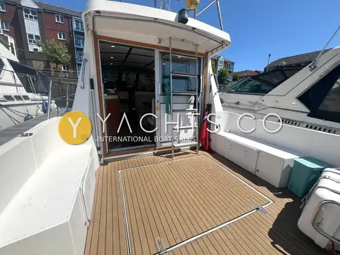 Aquastar Oceanranger 33: cockpit with synthetic teak decking and open saloon door, starboard side view