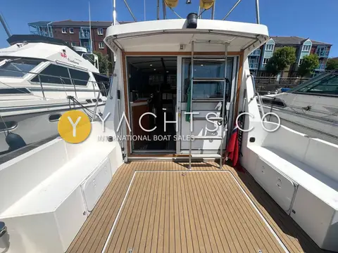 Aquastar Oceanranger 33: cockpit looking forward to saloon door, with synthetic teak floor and side seating