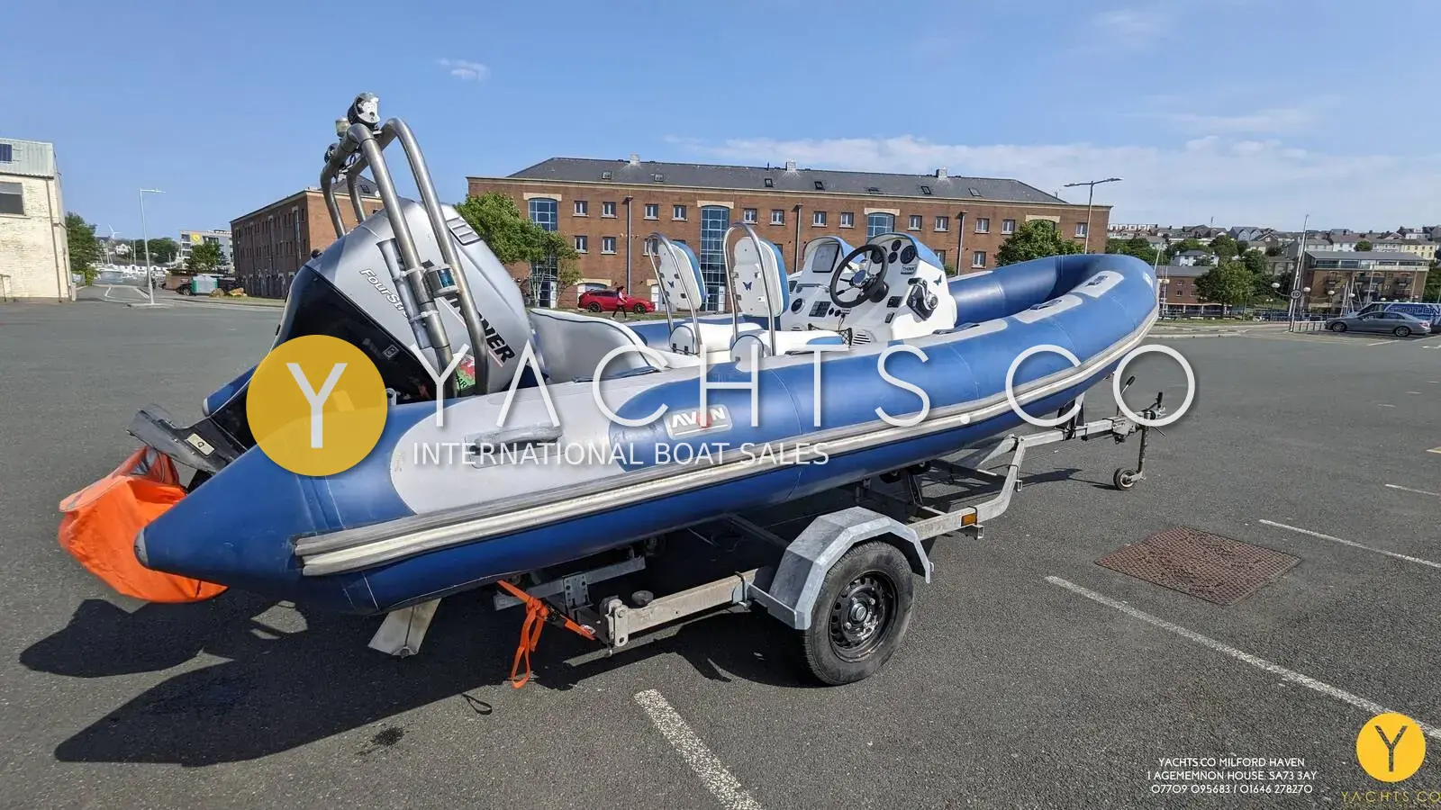 Avon 620 Adventure Rib: blue-tubed RIB on road trailer in car park, stainless A-frame and console visible
