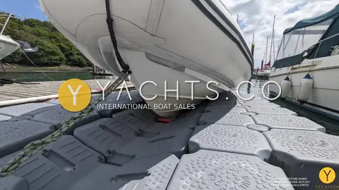 Avon Adventure 620 Rib & Trailer: close view of the white hull bow resting on the floating dock