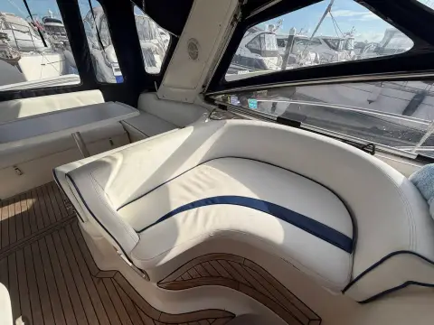 Bavaria 29 Sport: curved white cockpit seat with navy piping inside the canvas enclosure