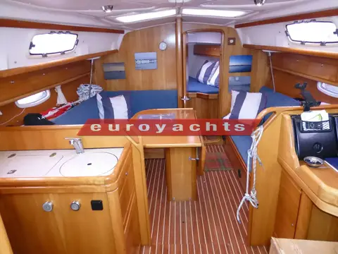 Bavaria 33 Cruiser: saloon looking forward to forward cabin, drop leaf table and blue settees