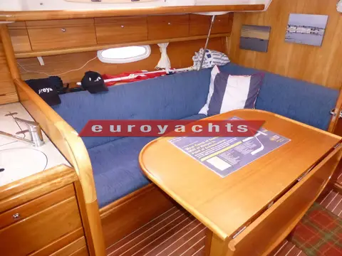 Bavaria 33 Cruiser: l shaped port settee with drop leaf dining table and storage lockers above