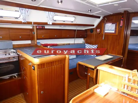 Bavaria 36: galley with stove and worktop, saloon settees and table beyond