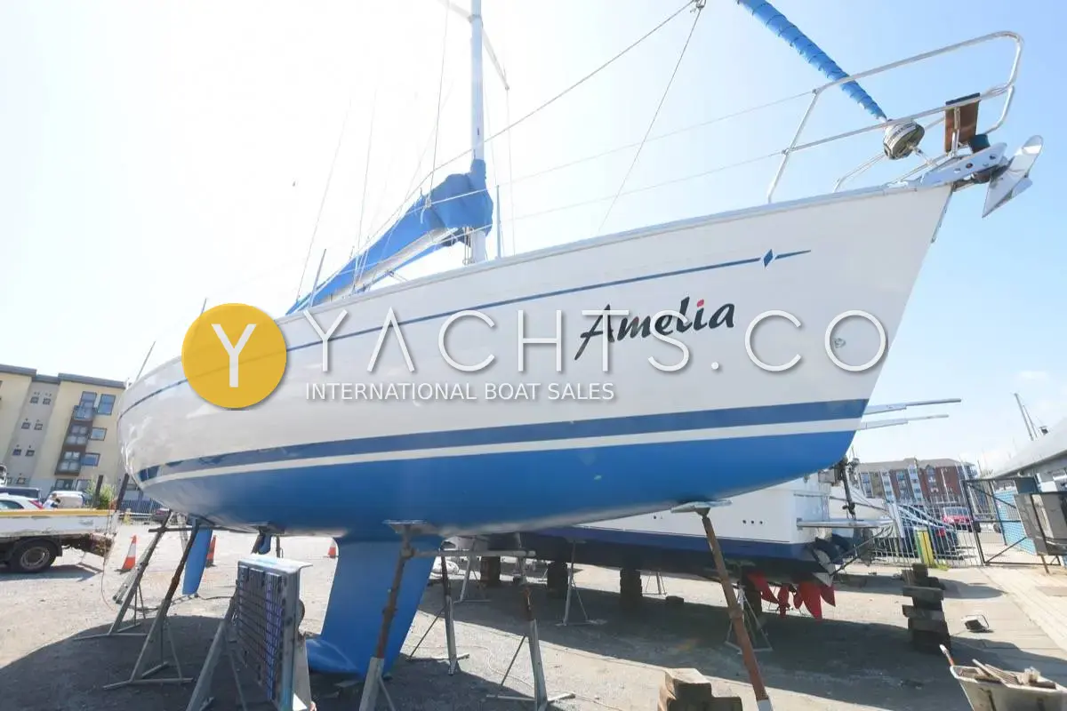 Bavaria 36 Holiday: white hull with blue boot stripe and name Amelia on the bow, ashore on stands