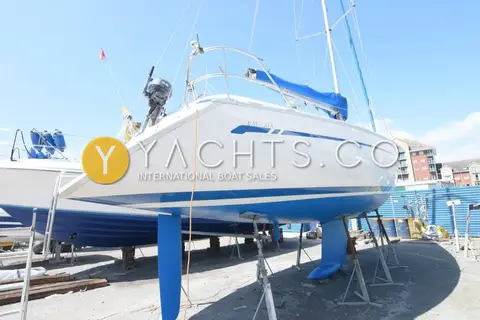 Bavaria 36 Holiday: stern quarter view ashore showing blue antifouled underwater hull and fin keel on stands