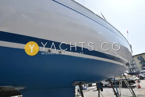 Bavaria 36 Holiday: topsides and blue underwater hull with through-hull fittings, propped up ashore