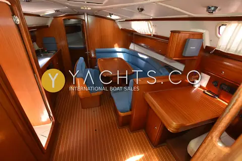 Bavaria 38: saloon looking forward, blue upholstery, wooden table and teak-and-holly sole