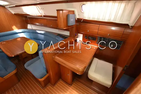 Bavaria 38: saloon with blue seating, folding table and chart table with seat