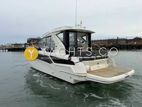 Bavaria S36: starboard quarter afloat with extended teak platform and dark hull glazing