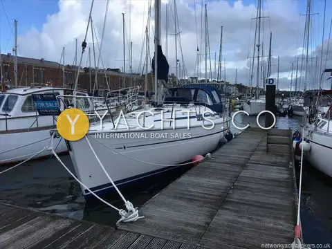 Bavaria Yachts Bavaria 36: white hull moored bow-on to pontoon in marina with blue sprayhood fitted