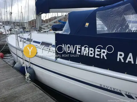 Bavaria Yachts Bavaria 36: topsides with blue stripe and blue dodgers lettered November Rain alongside pontoon