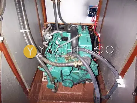 Bavaria Yachts Bavaria 40: engine bay showing the green Volvo Penta diesel with hoses and wiring