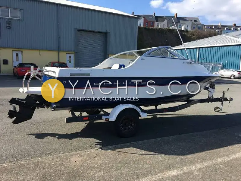 Bayliner 192 Cuddy: port side view on a galvanised single axle road trailer in a boatyard car park