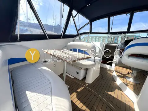 Bayliner 265: cockpit seating around the teak table, with pivoting helm seats beyond