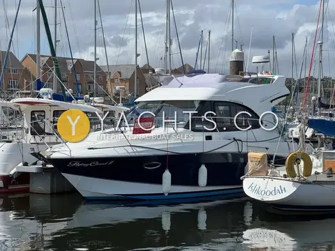 Beneteau Antares 30: side view of navy hull and white superstructure moored among sailing yachts