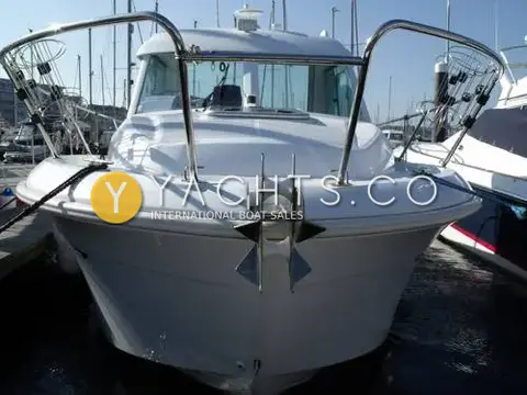 Beneteau Antares 6: bow view in marina showing stainless pulpit, fender baskets and anchor on bow roller