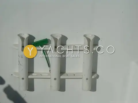 Beneteau Antares 6: close-up of three white rod holders mounted on a white cockpit panel