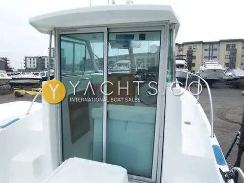 Beneteau Antares 620: sliding glass doors from the cockpit into the wheelhouse, wooden wheel visible inside