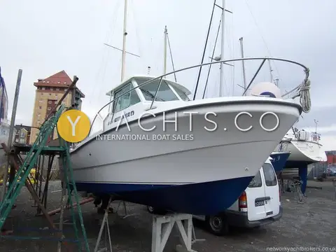 Beneteau Antares 620: hull ashore on stands in a boatyard, white topsides with blue antifouled bottom