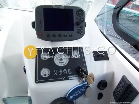 Beneteau Antares 7: helm console with Raymarine chartplotter above engine gauges, switch panel and ignition keys