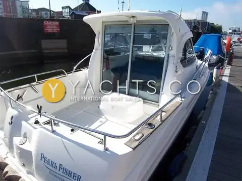 Beneteau Antares 7: aft cockpit and sliding wheelhouse doors seen from the stern, moored on a marina pontoon