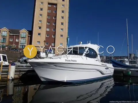 Beneteau Antares 7: starboard bow view of the white hull afloat in Swansea marina beside apartment blocks