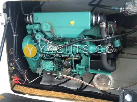 Beneteau Antares 7: engine bay showing the green Volvo diesel engine with hoses and wiring