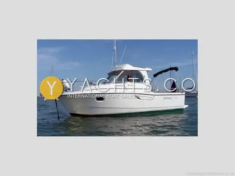 Beneteau Antares 7: starboard side view afloat at anchor with white hull and green antifouling
