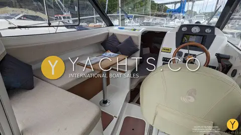 Beneteau Antares 7.80: wheelhouse with U-shaped settee to port, small table and wood-rimmed helm wheel