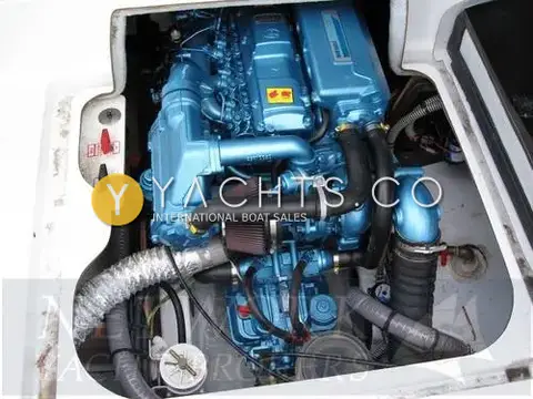 Beneteau Antares 710: engine bay with blue diesel engine, air filters and hoses seen from above