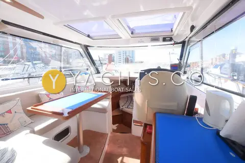 Beneteau Antares 8.80: wheelhouse looking forward to helm seat, dinette and twin overhead deck hatches