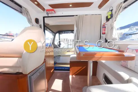 Beneteau Antares 8.80: wheelhouse looking aft past helm seat and dinette to sliding cockpit doors