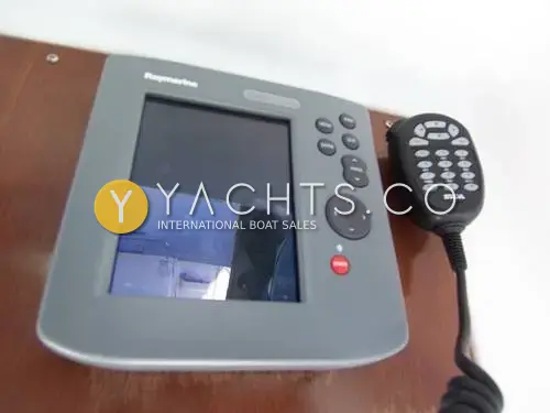 Beneteau Antares 9: raymarine display beside a Silva VHF handset mounted on wooden panel