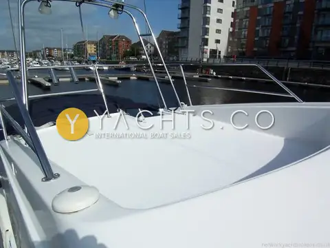 Beneteau Antares 9: flybridge seating area with stainless rails overlooking the marina