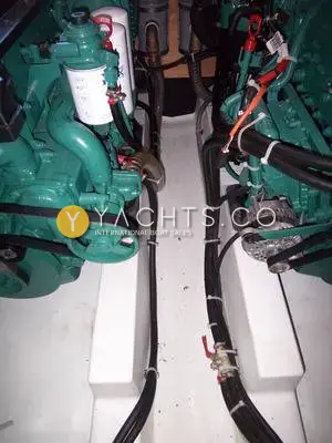 Beneteau Antares 9.80 Anniversary Edition: engine bay showing the twin green diesel engines side by side with neat cable runs