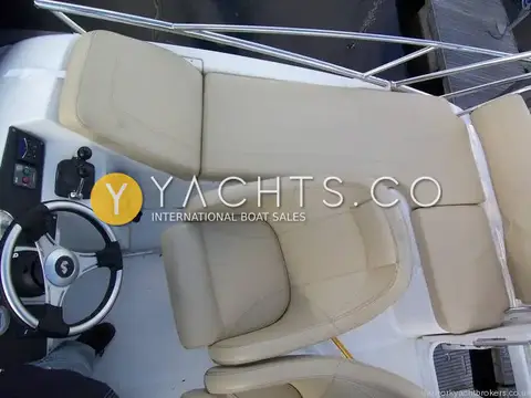 Beneteau Antares 9.80 Anniversary Edition: flybridge from above showing cream helm seat, L-shaped bench seating and wheel
