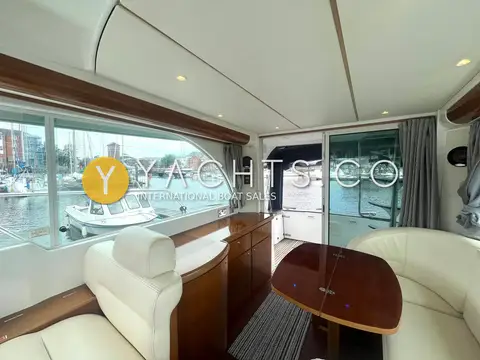 Beneteau Antares 980: saloon looking aft to sliding doors, with leather seating, wood counter and large windows