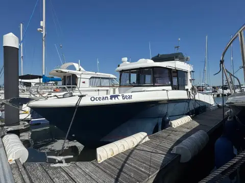 Beneteau Barracuda 9: port side moored at a marina pontoon with fenders out and name on hull
