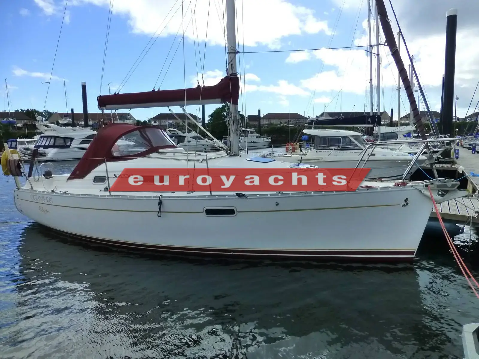 Beneteau Oceanis 281 Clipper: white hull afloat at a marina berth with burgundy sprayhood and boom cover