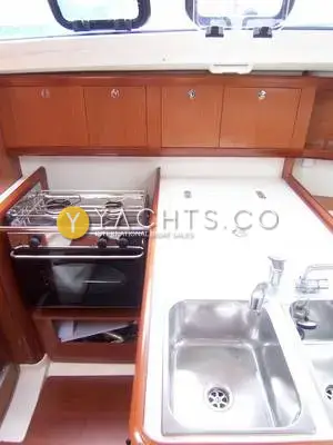 Beneteau Oceanis 31: galley with two-burner gimballed stove and oven, twin stainless sinks and lockers above