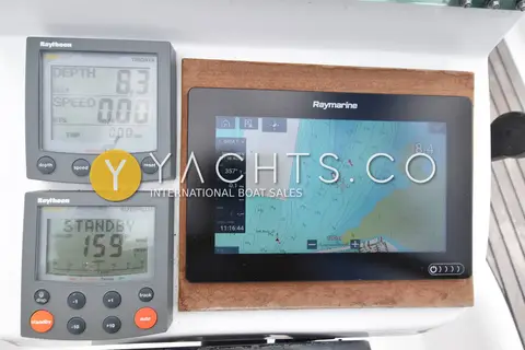 Beneteau Oceanis 331 Clipper: raymond chartplotter beside depth and autopilot instrument displays at the helm