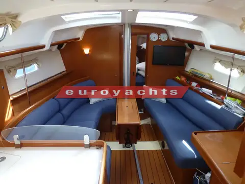Beneteau Oceanis 343: saloon with blue settees either side, central table, overhead hatches and television forward