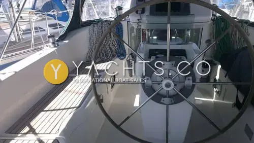 Beneteau Oceanis 351: cockpit with large stainless steering wheel, teak seats and coiled lines either side