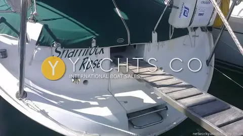 Beneteau Oceanis 351: sugar scoop stern with teak-slatted boarding passerelle deployed and life raft canister