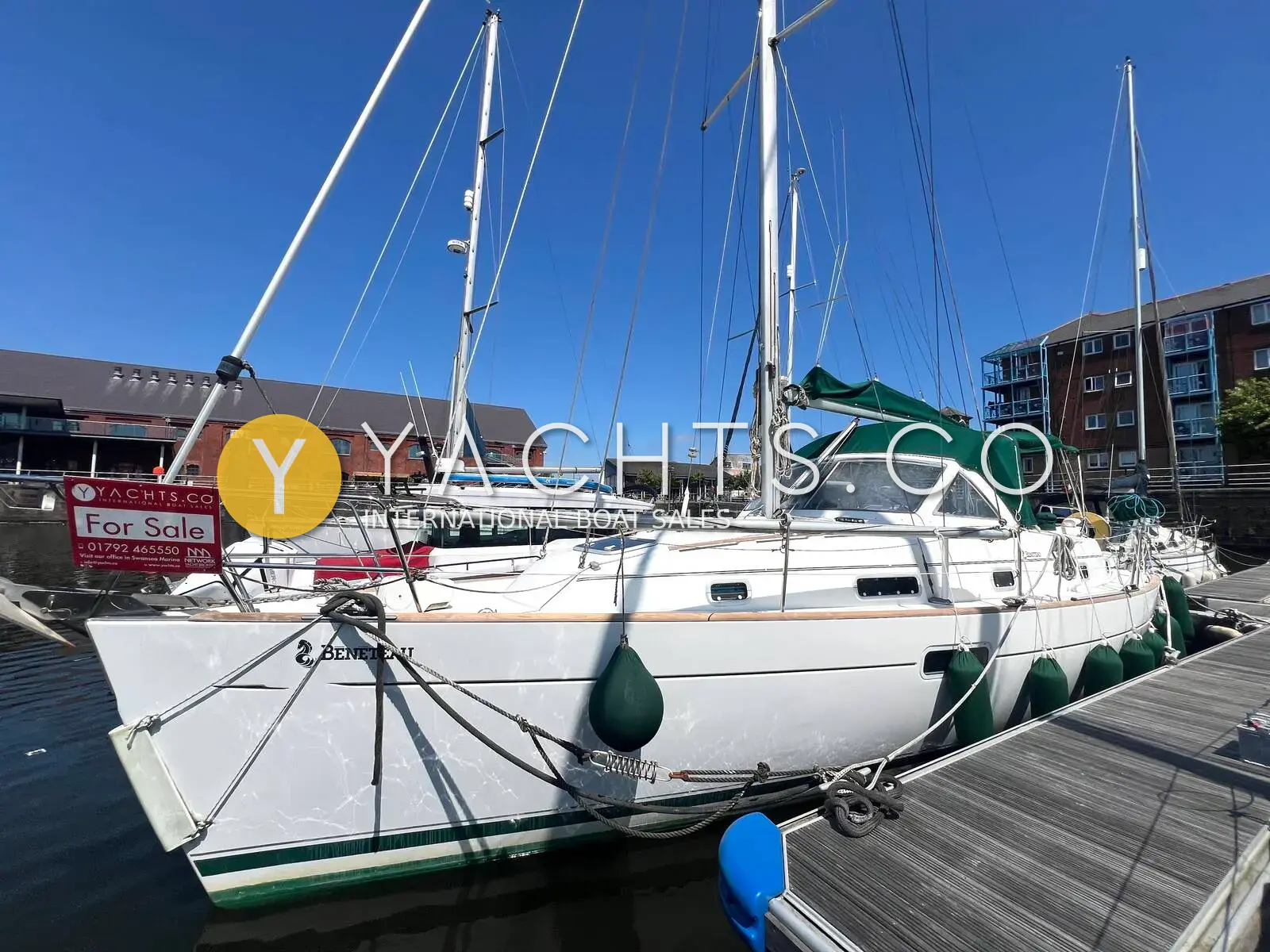 Beneteau Oceanis 36 CC: white hull with dark green enclosure moored alongside a pontoon in a marina