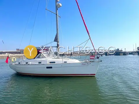 Beneteau Oceanis 36CC: port side view of the hull afloat with burgundy sprayhood and lifting bridge in background