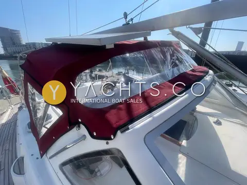 Beneteau Oceanis 36CC: burgundy sprayhood with clear windows over the fixed windscreen, side deck view